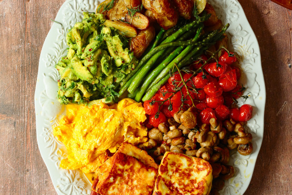 A veggie brunch platter with eggs, avocado, halloumi and all the trimmings